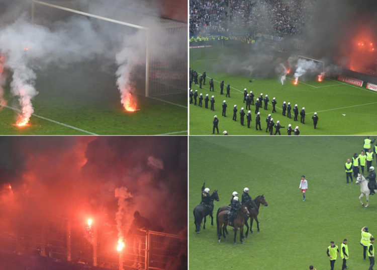Aficionados llenan el campo de bengalas tras el descenso del Hamburgo