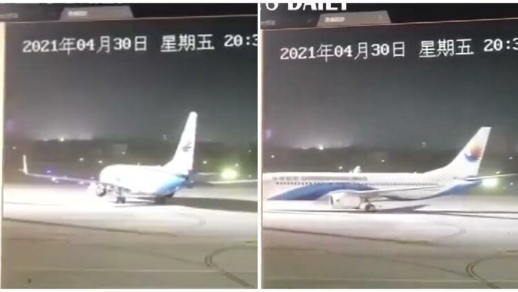 Un vendaval mueve a un avión en la pista de aterrizaje de un aeropuerto en China